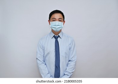 Asian Male Office Worker Wearing Face Mask, White Background.