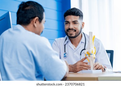 Asian male orthopedics professional doctor consulting explaining knee bone model to male patient, Physiotherapist explain an anatomical human knee-joint to an elderly patient. Concept physio treatment - Powered by Shutterstock