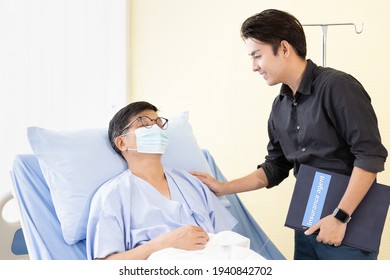 Asian Male Patient On Hospital Bed And Care From Insurance Agent. Medical Expenses, Health Insurance, Life Insurance And Financial Planning