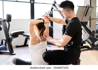 Asian Male Personal Trainer Who Teaches Stretching