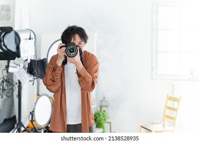 Asian male photographer with camera
