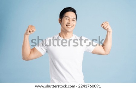 Asian male portrait posing on blue background