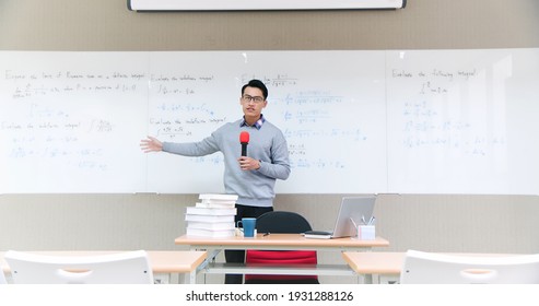 asian male professor teach calculus online through webcam in classroom