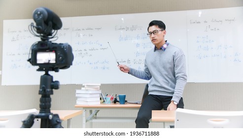 Asian Male Professor Teach Calculus Online Through Camera In Classroom