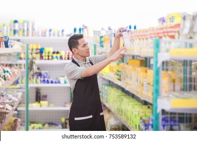 Asian Male Shopkeeper Working In A Grocery Store