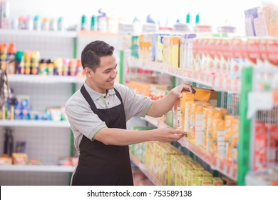 Asian Male Shopkeeper Working In A Grocery Store