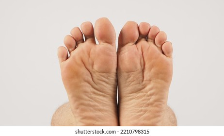 Asian Male Soles Barefoot Are Isolated On White Background.