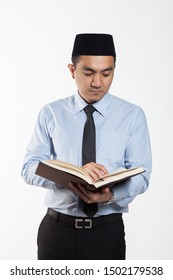 Asian Male With Songkok Reading A Book