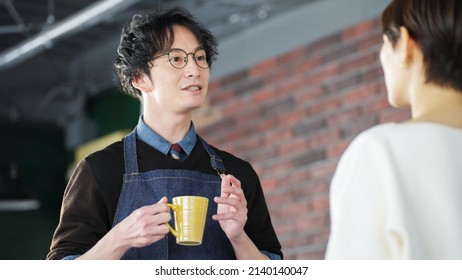 Asian male staff and customers - Powered by Shutterstock