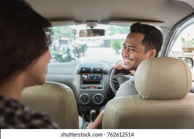asian male taxi driver welcoming his customer