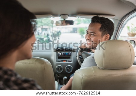 asian male taxi driver welcoming his customer