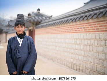 Asian Male Teenager Wear The South Korean National Costume Visit The Gyeongbokgung Palace, Seoul South Korea.