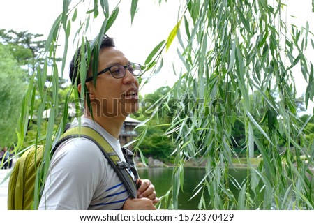 Similar – Portrait of a young man in the bamboo jungle