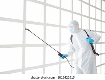 Asian Male Wear PPE Protective Suit Use Spray Device For Cleaning Disinfect Inside A Building Or Office,To Prevent Spread Of Disease From Crisis Of Coronavirus (COVID‑19) Outbreak.New Normal Concept.