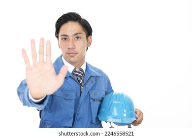 Asian male worker making stop gesture - Shutterstock ID 2246558521