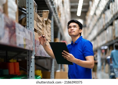 Asian male worker in security suit with tablet computer looking for items in a large warehouse.
Workers in a distribution center. Logistics and export of business. - Powered by Shutterstock