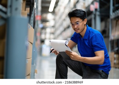 An Asian male worker in a warehouse checks cardboard boxes. delivery in logistics Distribution center . Logistics and export of business. factory warehouse - Powered by Shutterstock