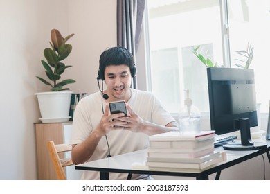 Asian Man Administrator Staff Call Center In Home Service Office Assistance Work From Home Looking Data Customer From Computer Communication During Coronavirus Covid-19