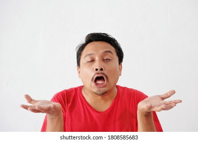 Asian Man With Annoying Face And Eye Rolling Expression, Isolated In White. Can Be Used For Undesirable Situation Response, Disagree Or Dismiss Gesture