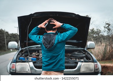 Asian Man Anxiety About The Car Breaking Down  While Traveling.