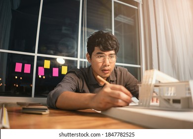 Asian Man Architect Making Architecture Model Of House Style Modern. Young Man Architect Working In The Office.