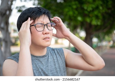 Asian Man Athlete Feeling Dizzy And Tired While Doing Outdoor Exercise In The Park. Sport Overtraining Or Heat Stroke Concept