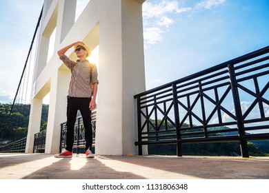 Asian man backpack standing alone on bridge, outdoor tourist lifestyle nature happy time.