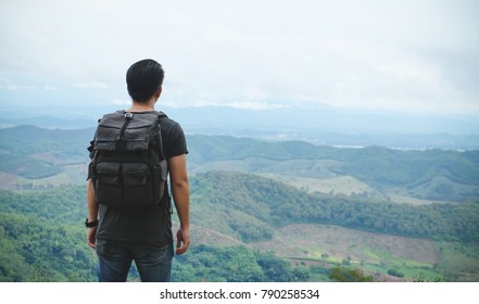 Asian man backpacker/traveler over high view of top mountain lan