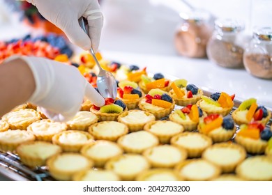 Asian Man Bakery Shop Owner Preparing Bakery In The Kitchen. Male Pastry Chef Making Fruit Tart With Cream Cheese On Kitchen Counter. Small Business Entrepreneur And Indoor Activity Lifestyle Concept.