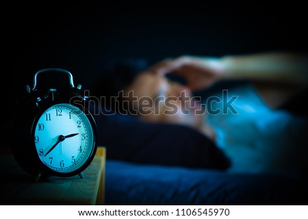 asian man in bed suffering insomnia and sleep disorder thinking about his problem at night