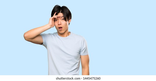 Asian man with blue shirt has just realized something and has intending the solution over isolated blue background - Shutterstock ID 1445475260