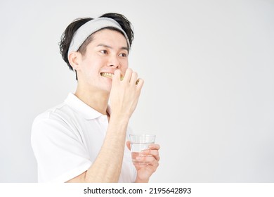 Asian Man Brushing His Teeth In White Background