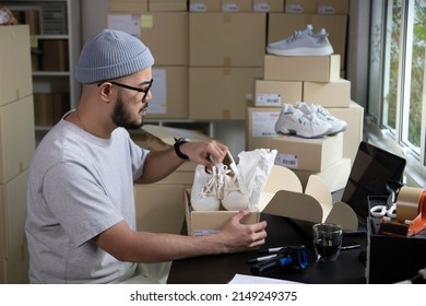 Asian Man Business Owner Working, Packing The Order For Shipping To Customer. Male Entrepreneur Packaging Box For Delivery In Store Warehouse.