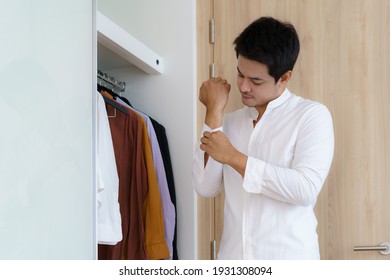 Asian Man Are Buttoned Up Their Shirts To Get Dressed, Getting Ready To Go To Work In The Morning In The Dressing Room At Home.
