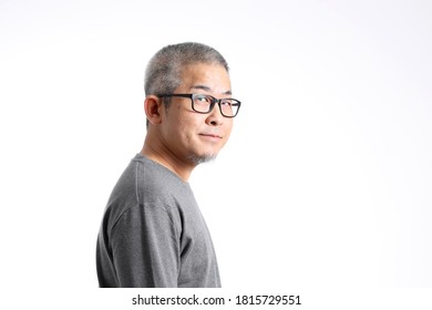 The Asian Man With Buzz Hair Standing On The White Background.