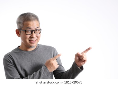 The Asian Man With Buzz Hair Standing On The White Background.