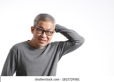 The Asian Man With Buzz Hair Standing On The White Background.