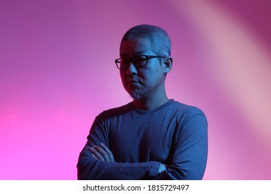 The Asian Man With Buzz Haircut Is Shot With Studio Gel Lighting.