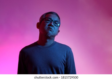 The Asian Man With Buzz Haircut Is Shot With Studio Gel Lighting.