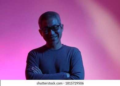 The Asian Man With Buzz Haircut Is Shot With Studio Gel Lighting.