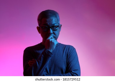 The Asian Man With Buzz Haircut Is Shot With Studio Gel Lighting.