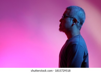 The Asian Man With Buzz Haircut Is Shot With Studio Gel Lighting.