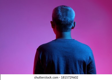 The Asian Man With Buzz Haircut Is Shot With Studio Gel Lighting.