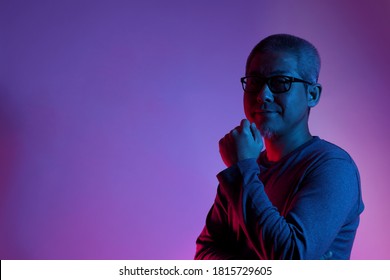 The Asian Man With Buzz Haircut Is Shot With Studio Gel Lighting.