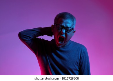 The Asian Man With Buzz Haircut Is Shot With Studio Gel Lighting.