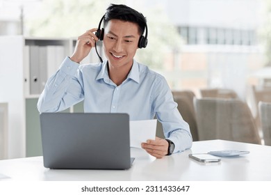 Asian man, call center and laptop with document in customer service, telemarketing or support at office. Happy male person or consultant agent with paperwork on computer in online advice at workplace - Powered by Shutterstock