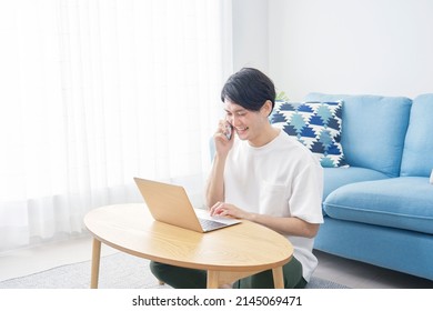 Asian man calling with the smartphone at home