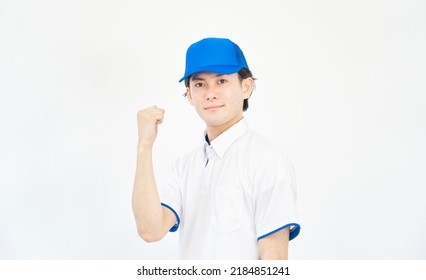 Asian Man In A Cap And Polo Shirt Uniform Guts Pose Gesture In White Background