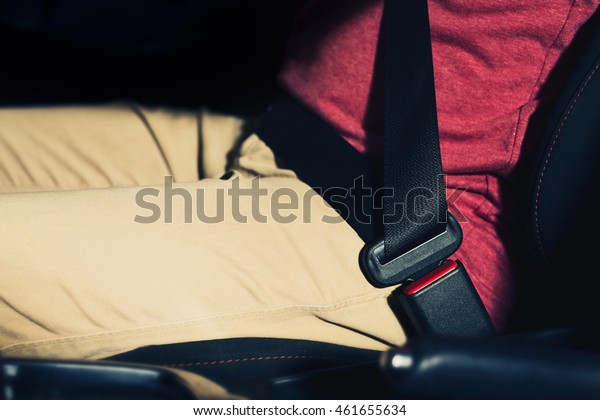 Asian man in a car, close up at car safety\
belt hipster vintage process\
photography.