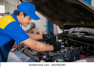 Asian Man In Car Service, Repair, Maintenance And People Concept, Happy Smiling Auto Mechanic Man Or Smith With Clipboard At Workshop